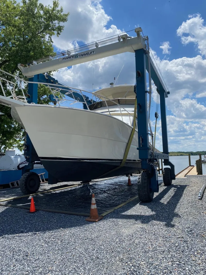 Slide: The Image of 1990 Viking 45 Convertible yacht on a Marine Travelift, clear sky background. - 3