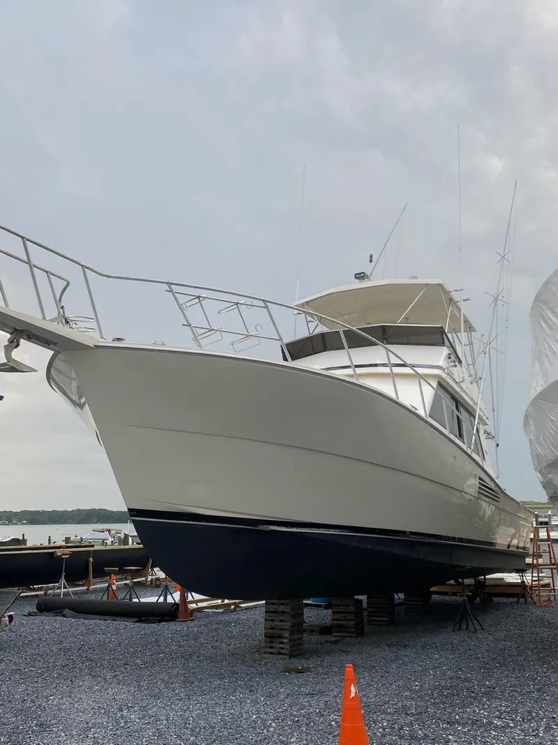 Slide: The Image of 1990 Viking 45 Convertible yacht on dry dock, overcast sky background. - 5