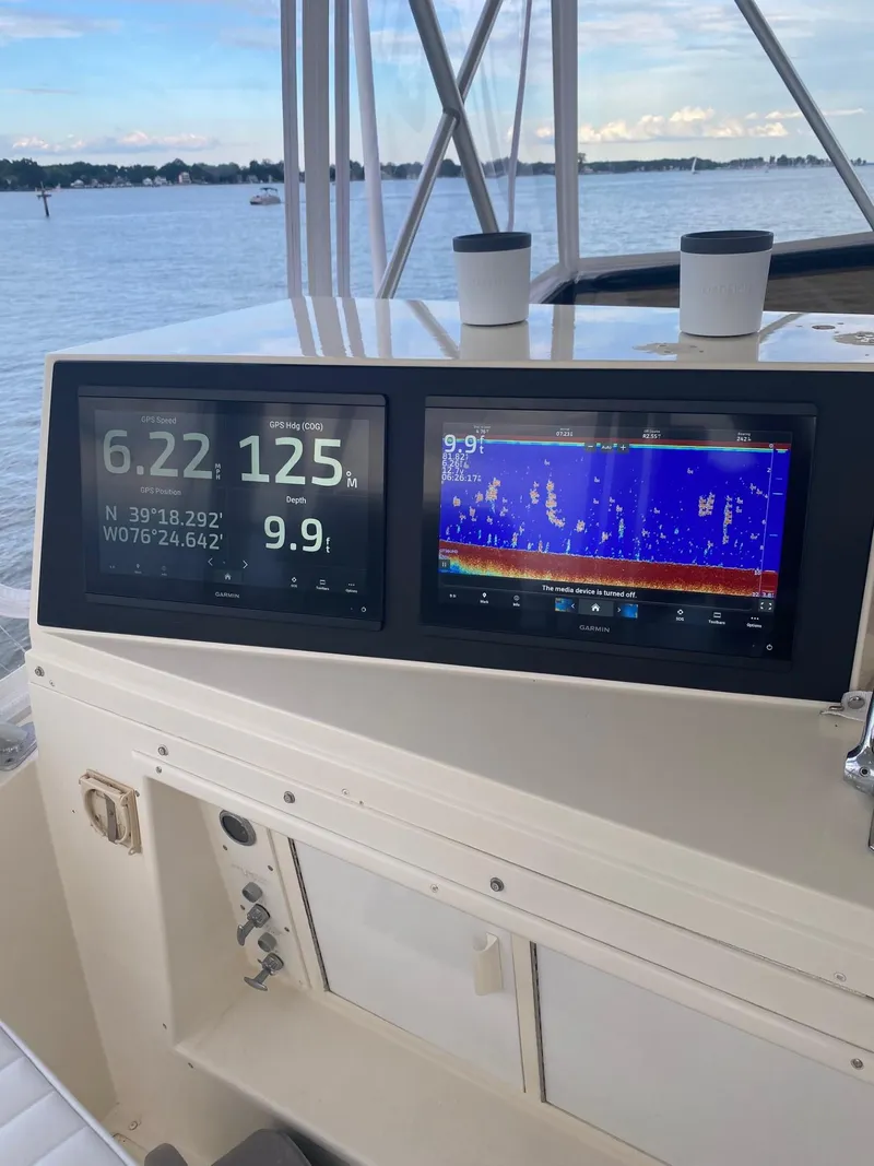 Slide: The Image of Boat navigation system on a 1990 Viking 45 Convertible, displaying GPS and sonar data. - 7