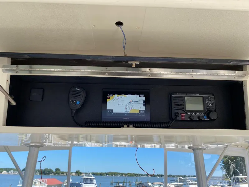 Slide: The Image of 1990 Viking 45 Convertible boat dashboard with navigation and communication equipment. - 9