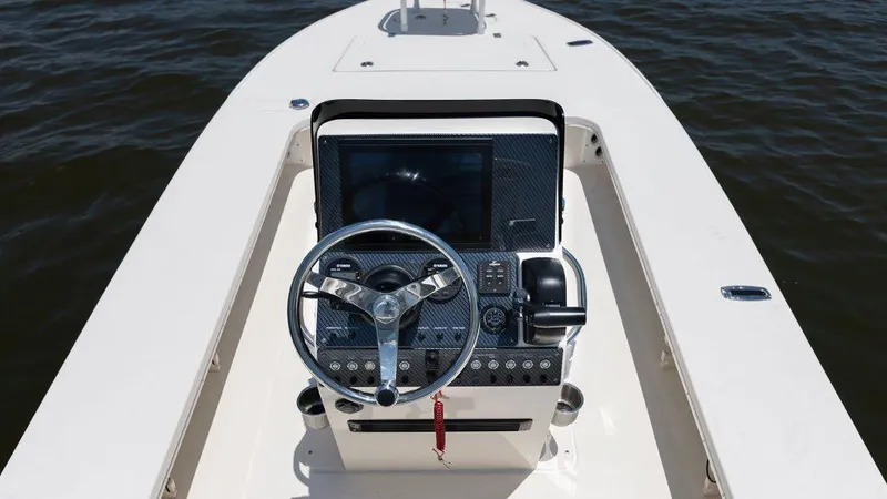 Slide: The Image of 2024 Sterling 180TS boat console with steering wheel and navigation controls. - 3