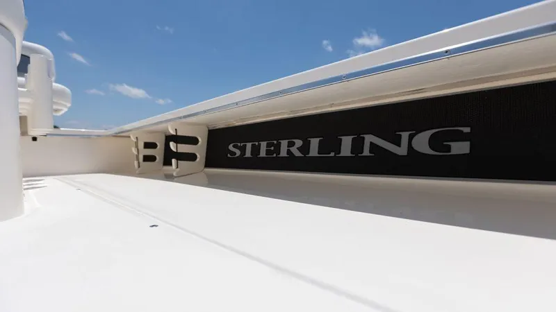 Slide: The Image of 2024 Sterling 180TS boat deck with logo under clear blue sky. - 4