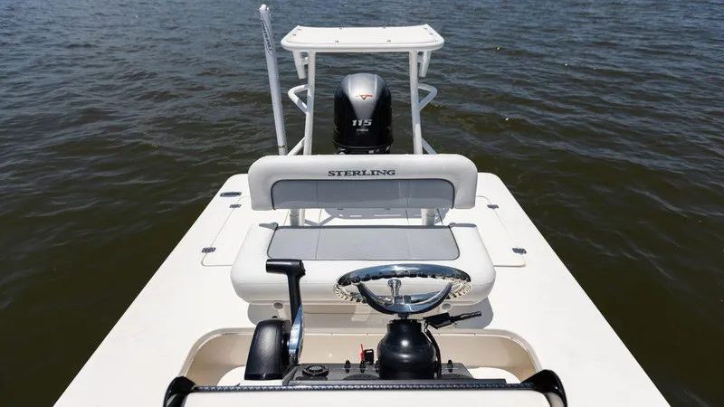 Slide: The Image of 2024 Sterling 180TS boat with outboard motor on calm water. - 7