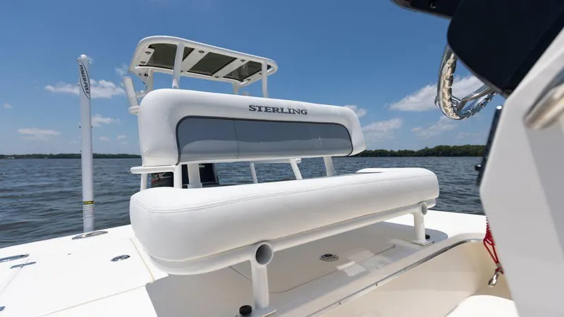 Slide: The Image of 2024 Sterling 180TS boat with white seating, on a calm lake under a clear blue sky. - 8