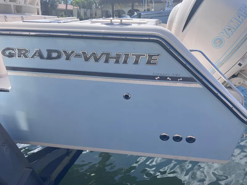 Slide: The Image of 2018 Grady-White Canyon 336 boat, side view with logo and Yamaha engine. - 12