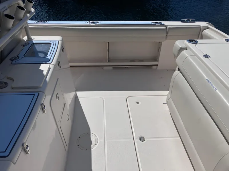 Slide: The Image of 2018 Grady-White Canyon 336 boat deck, featuring storage compartments and seating. - 16