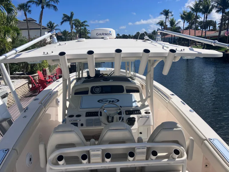 Slide: The Image of 2018 Grady-White Canyon 336 boat on a sunny canal with palm trees. - 19