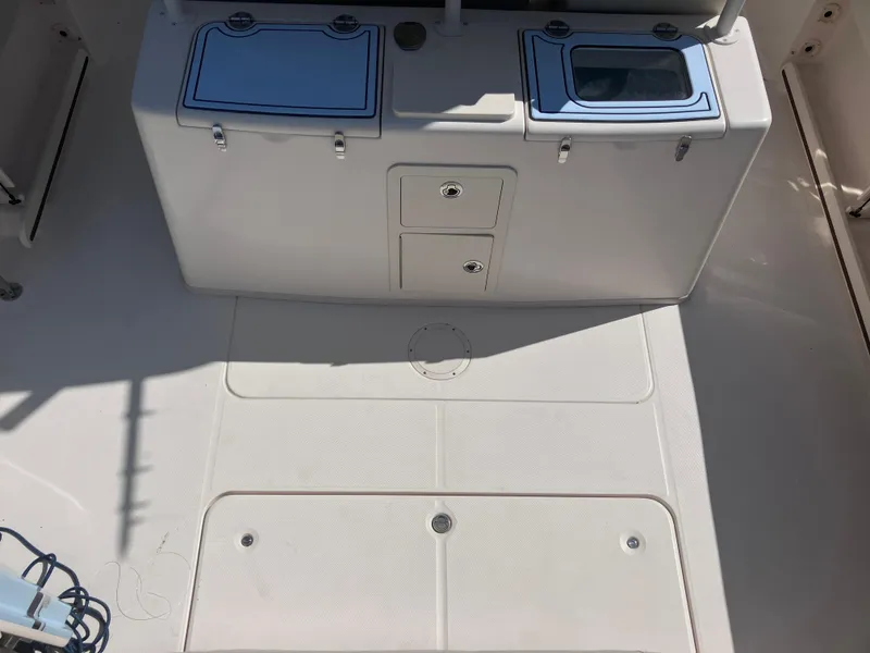 Slide: The Image of 2018 Grady-White Canyon 336 boat deck with storage compartments and clean surface. - 20