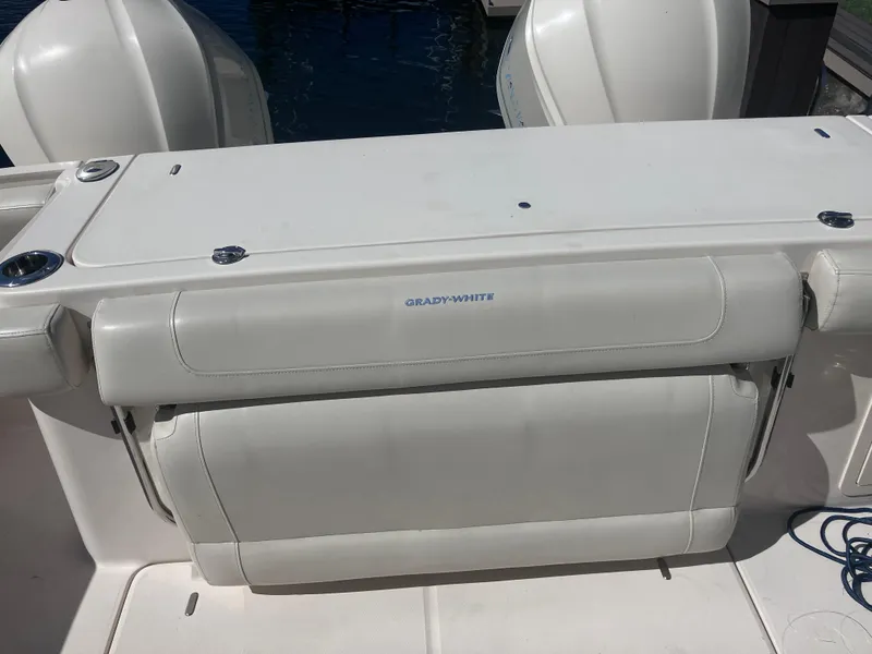 Slide: The Image of 2018 Grady-White Canyon 336 boat, rear seating area with visible outboard engines. - 21
