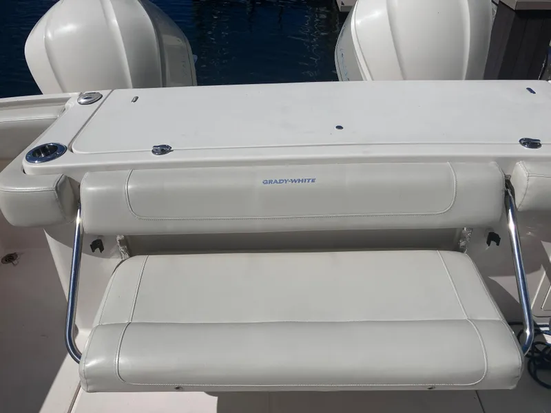 Slide: The Image of 2018 Grady-White Canyon 336 boat seat with white upholstery and stainless steel supports. - 22
