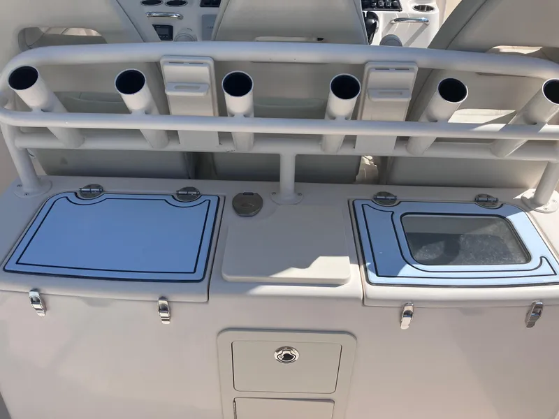 Slide: The Image of 2018 Grady-White Canyon 336 boat console with rod holders and storage compartments. - 25
