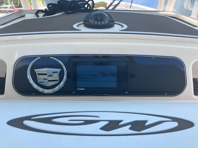 Slide: The Image of 2018 Grady-White Canyon 336 dashboard with compass and electronic display. - 31