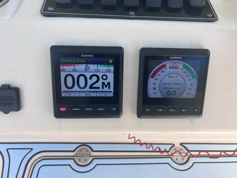 Slide: The Image of Garmin navigation displays on 2018 Grady-White Canyon 336 boat dashboard. - 32