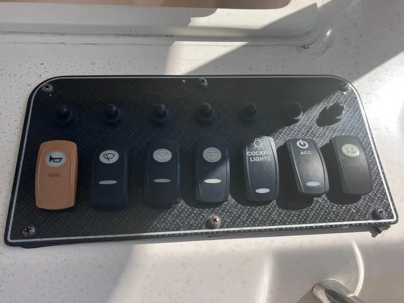 Slide: The Image of Control panel of a 2018 Grady-White Canyon 336 boat with labeled switches. - 34