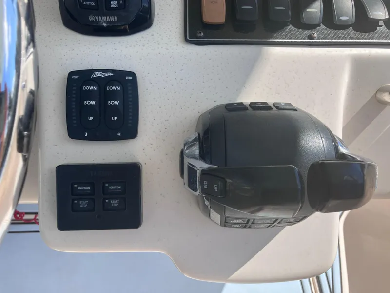 Slide: The Image of Control panel of a 2018 Grady-White Canyon 336 boat with throttle and trim tabs. - 35