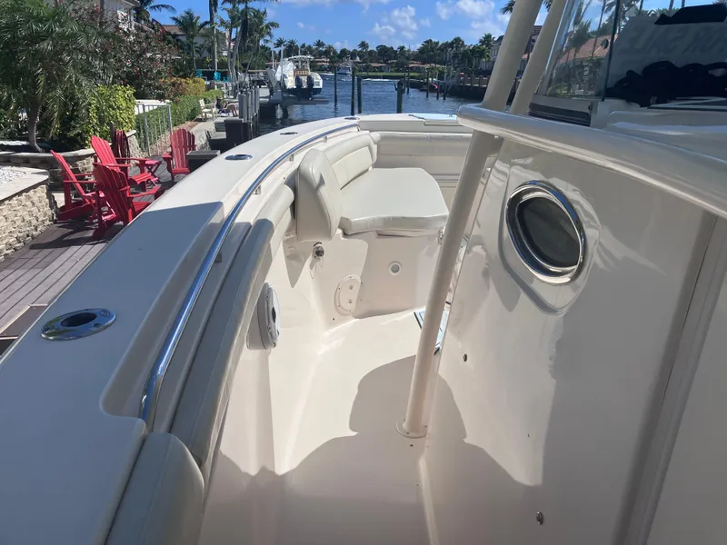 Slide: The Image of 2018 Grady-White Canyon 336 boat, spacious deck, docked near waterfront homes. - 40