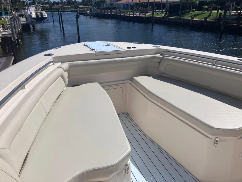 Slide: The Image of 2018 Grady-White Canyon 336 boat interior with cushioned seating by the water. - 42