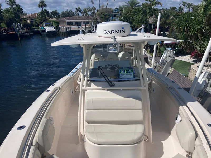 Slide: The Image of 2018 Grady-White Canyon 336 boat for sale, docked near waterfront homes. - 47