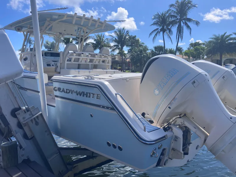 Slide: The Image of 2018 Grady-White Canyon 336 boat docked, featuring Yamaha outboard engines, under a sunny sky. - 8