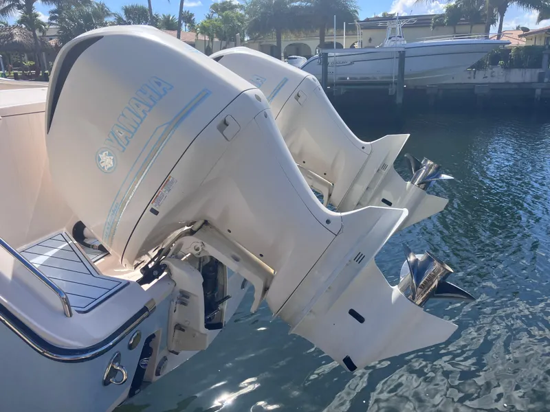 Slide: The Image of Twin Yamaha outboard engines on a 2018 Grady-White Canyon 336 boat docked by the water. - 9