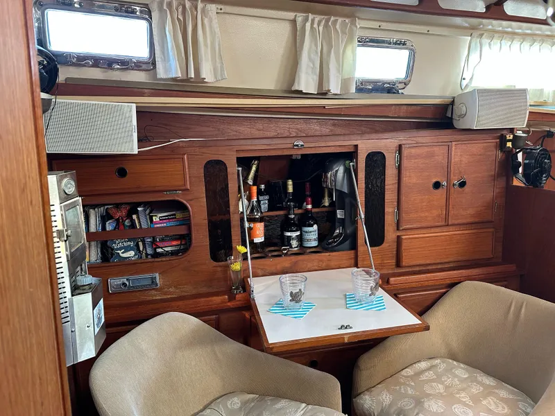 Slide: The Image of Interior of 1983 Whitby 42 Ketch with wooden cabinetry and cozy seating area. - 12