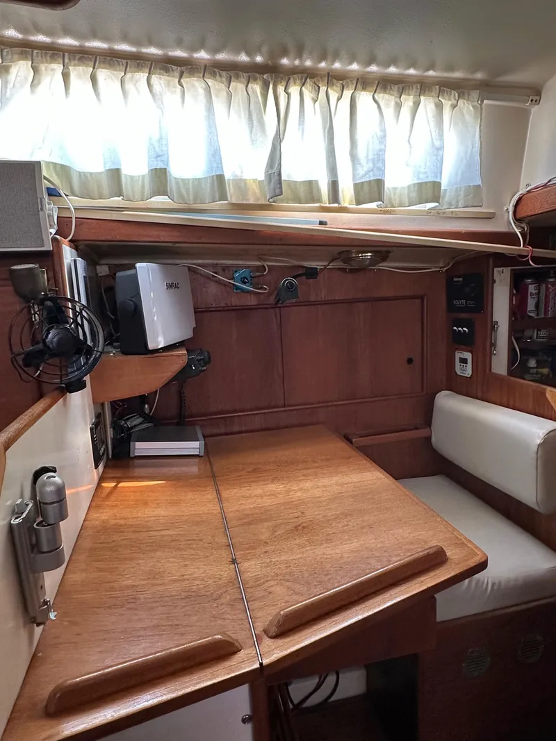 Slide: The Image of 1983 Whitby 42 Ketch interior with wooden table and seating area. - 14