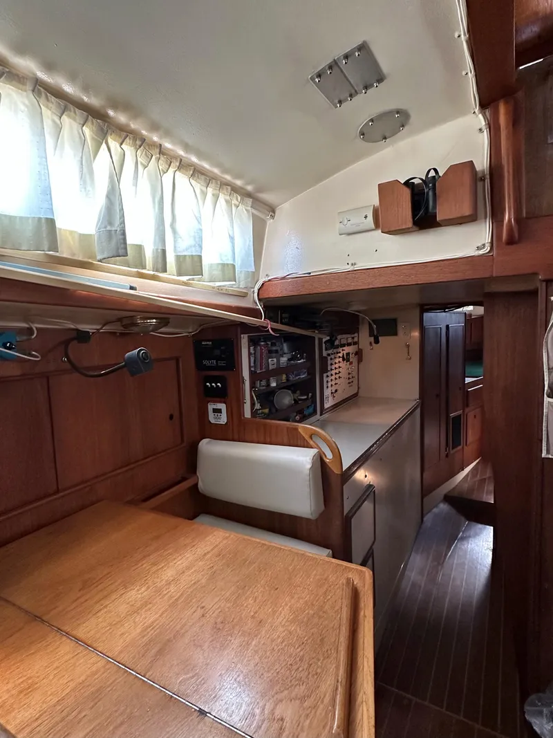 Slide: The Image of Interior of 1983 Whitby 42 Ketch sailboat, featuring wood paneling and compact design. - 15