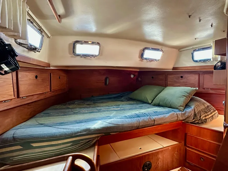 Slide: The Image of Cozy cabin interior of 1983 Whitby 42 Ketch with wooden furnishings and bed. - 18