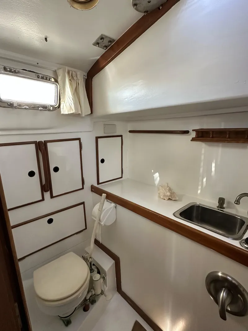 Slide: The Image of 1983 Whitby 42 Ketch bathroom with sink, toilet, and storage cabinets. - 20
