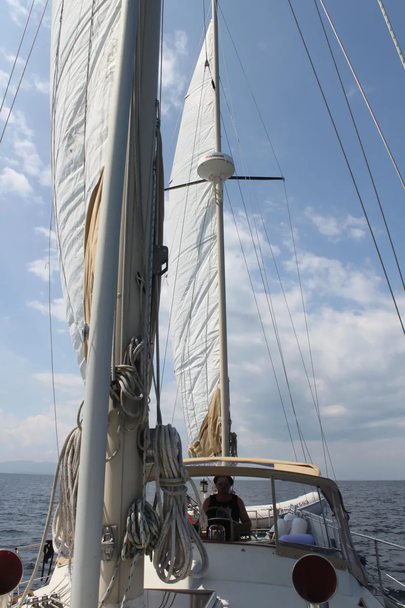 Slide: The Image of 1983 Whitby 42 Ketch sailing on open water under clear skies. - 8