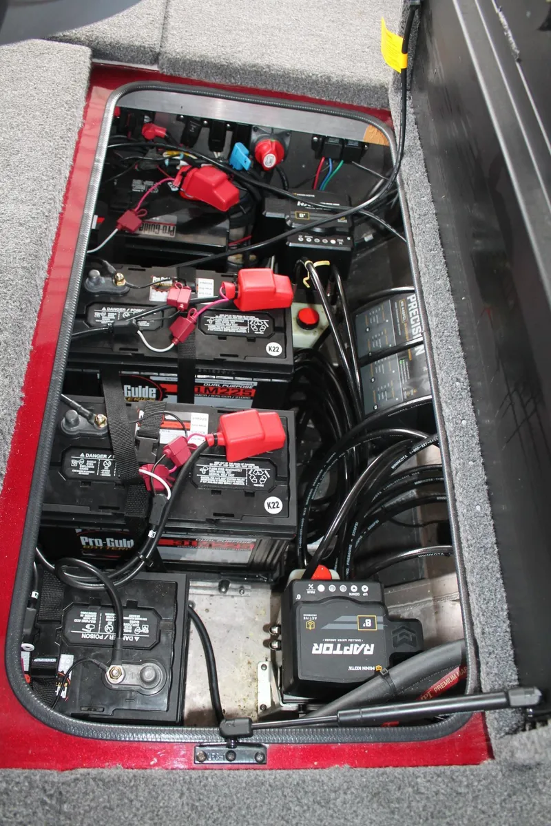 Slide: The Image of Battery compartment of 2023 Vexus AVX2080 boat with multiple batteries and wiring. - 12