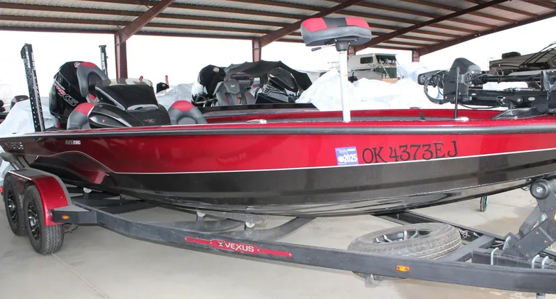 Slide: The Image of 2023 Vexus AVX2080 boat in red and black, parked on a trailer under a shelter. - 14