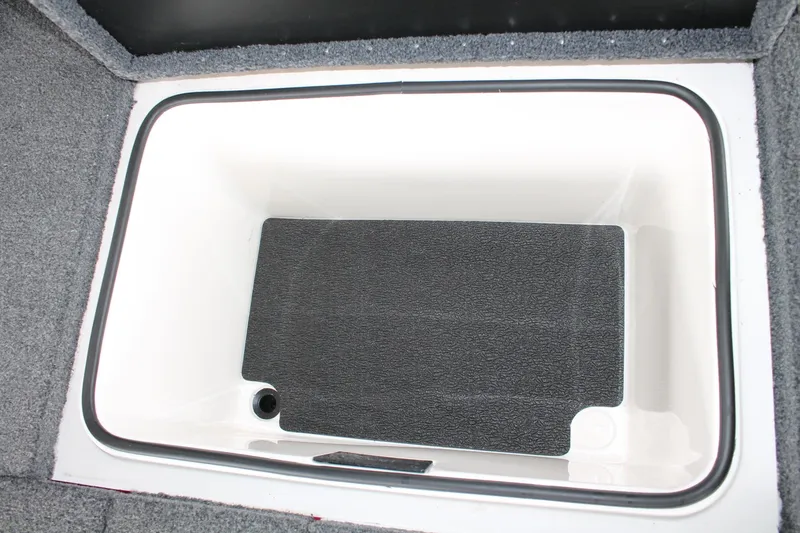 Slide: The Image of 2023 Vexus AVX2080 boat storage compartment with black mat and gray carpet lining. - 28