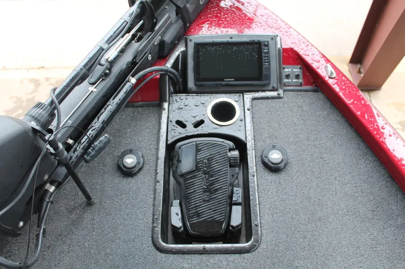 Slide: The Image of 2023 Vexus AVX2080 boat dashboard with Garmin electronics and foot pedal, wet from rain. - 5