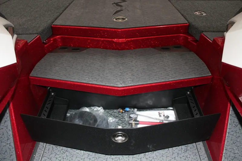 Slide: The Image of 2025 Vexus VXS21 boat storage compartment with red accents and organized interior. - 16