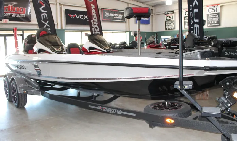 Slide: The Image of 2025 Vexus VXS21 boat displayed indoors on a trailer. - 2