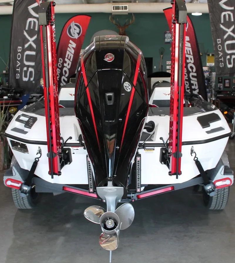 Slide: The Image of 2025 Vexus VXS21 boat with Mercury engine, displayed indoors with promotional banners. - 26