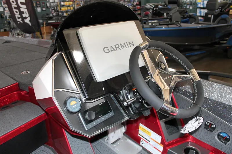 Slide: The Image of 2025 Vexus VXS21 boat dashboard with Garmin display and steering wheel. - 32