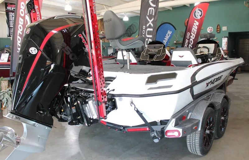 Slide: The Image of 2025 Vexus VXS21 boat with powerful engine, displayed indoors with promotional banners. - 7