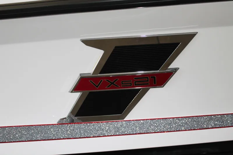 Slide: The Image of 2025 Vexus VXS21 logo on a sleek white surface with red and silver accents. - 9