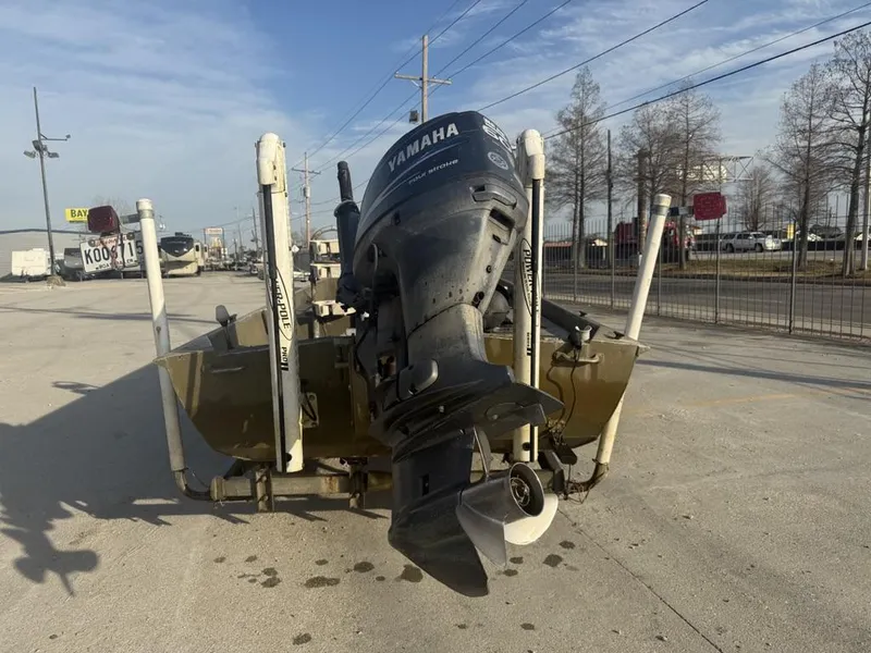 Slide: The Image of 2003 Gator Trax 20' boat with Yamaha outboard motor, parked outdoors. - 10