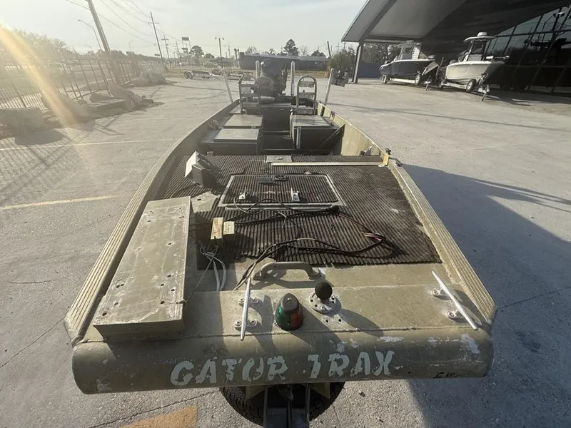 Slide: The Image of 2003 Gator Trax 20' boat in a parking lot, showing deck and equipment. - 11