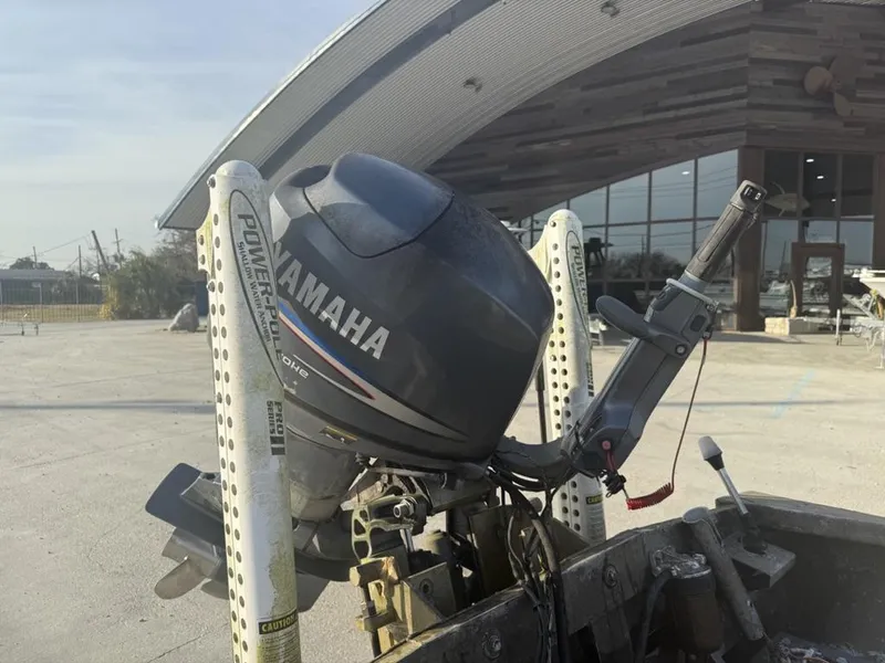 Slide: The Image of Yamaha outboard motor on 2003 Gator Trax 20' boat, parked near a modern building. - 12