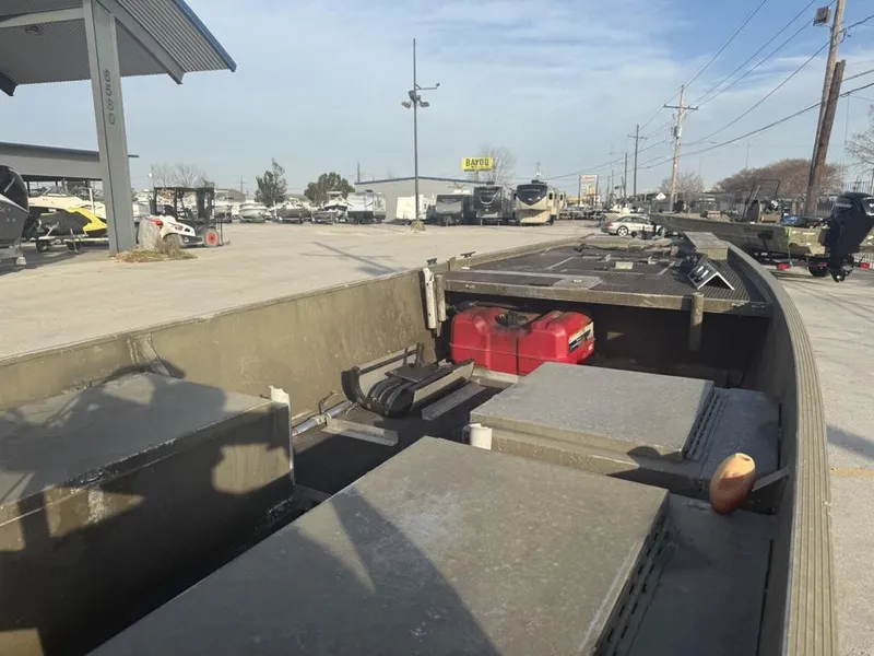 Slide: The Image of 2003 Gator Trax 20' boat interior at a dealership, showcasing storage and equipment. - 13