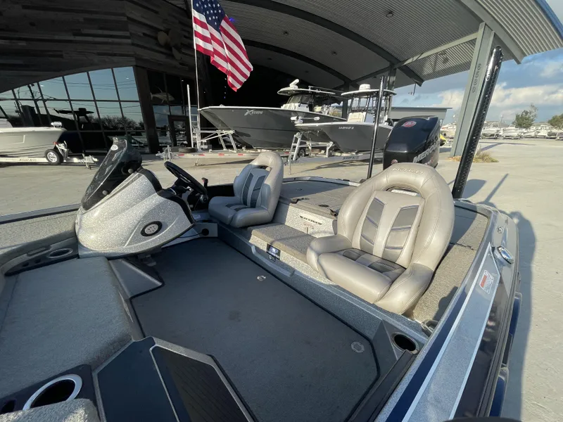 Slide: The Image of 2017 Nitro Z19 boat interior with steering console and seating, displayed outdoors under a canopy. - 3