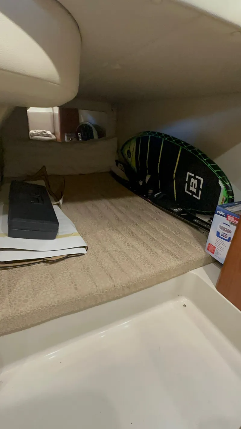 Slide: The Image of 2003 Chaparral 330 Signature Cruiser interior storage area with surfboard and equipment. - 12