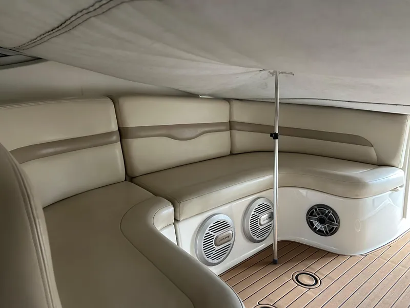 Slide: The Image of 2003 Chaparral 330 Signature Cruiser interior with beige seating and wood flooring. - 13