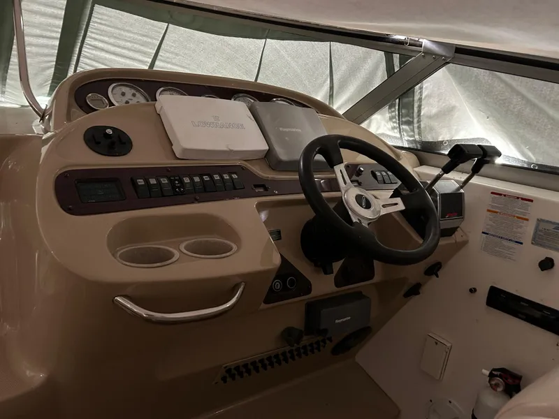 Slide: The Image of 2003 Chaparral 330 Signature Cruiser helm with steering wheel and control panel. - 14
