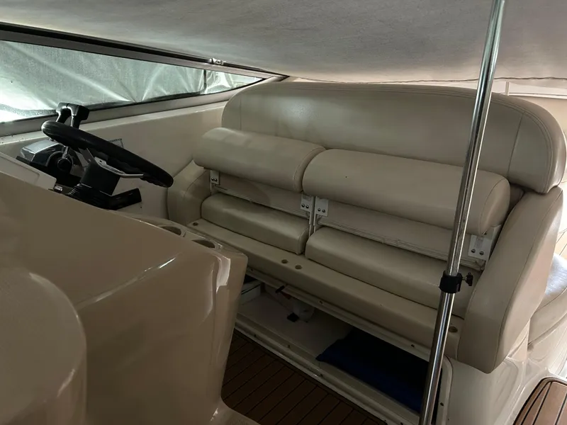Slide: The Image of 2003 Chaparral 330 Signature Cruiser interior with beige seating and steering wheel. - 15