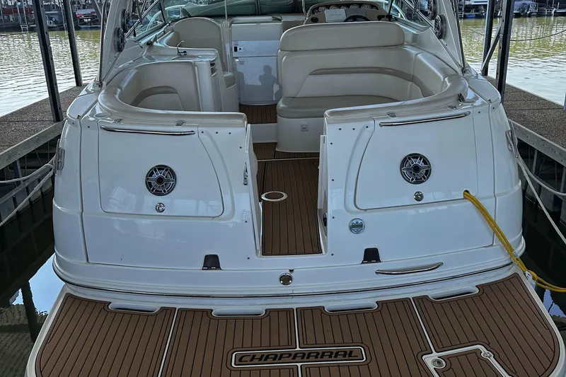 Slide: The Image of 2003 Chaparral 330 Signature Cruiser, rear view, docked with open seating area. - 2